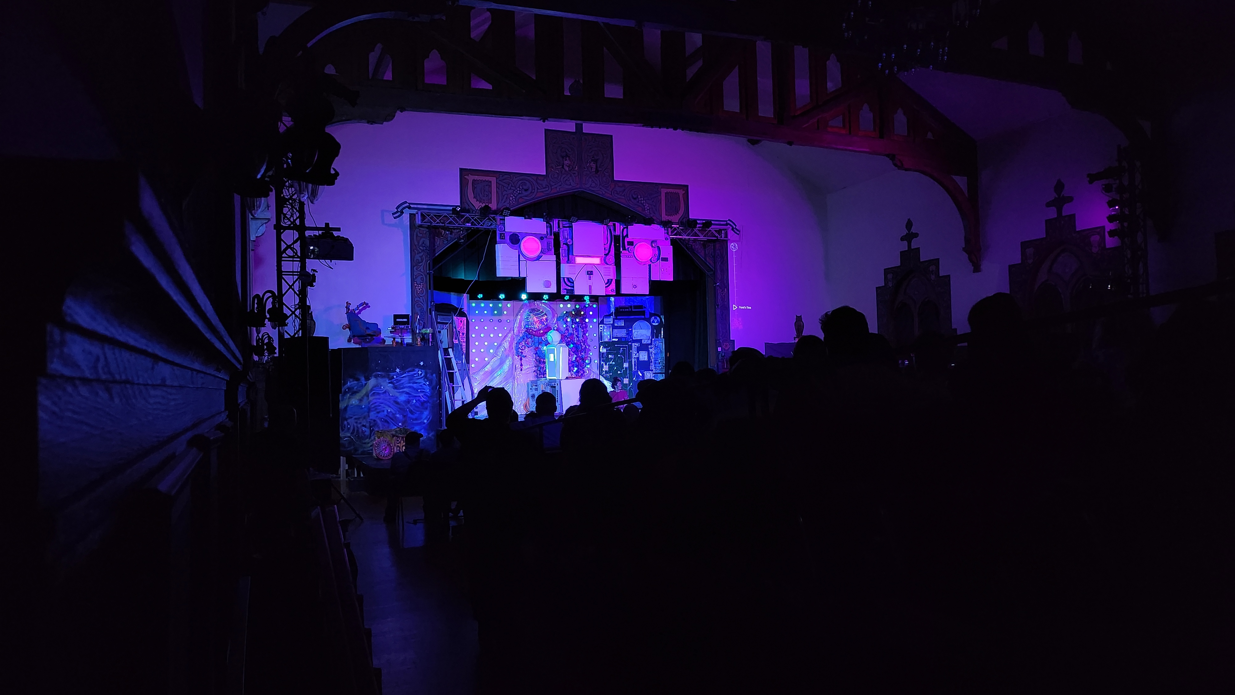 Charlie's face hangs above the stage